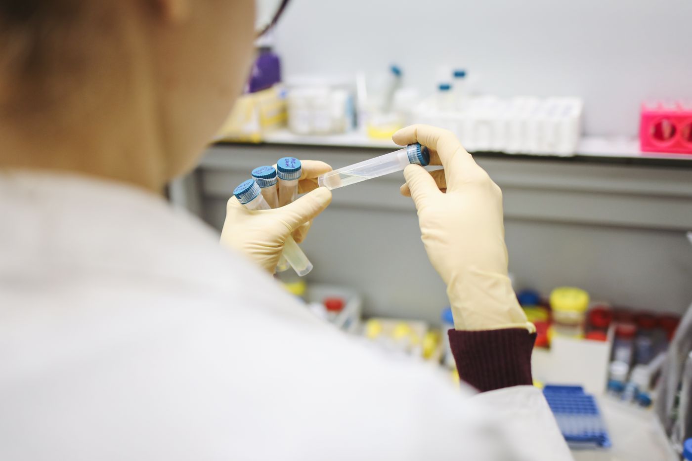 Technicienne de laboratoire examinant des tubes d’analyse